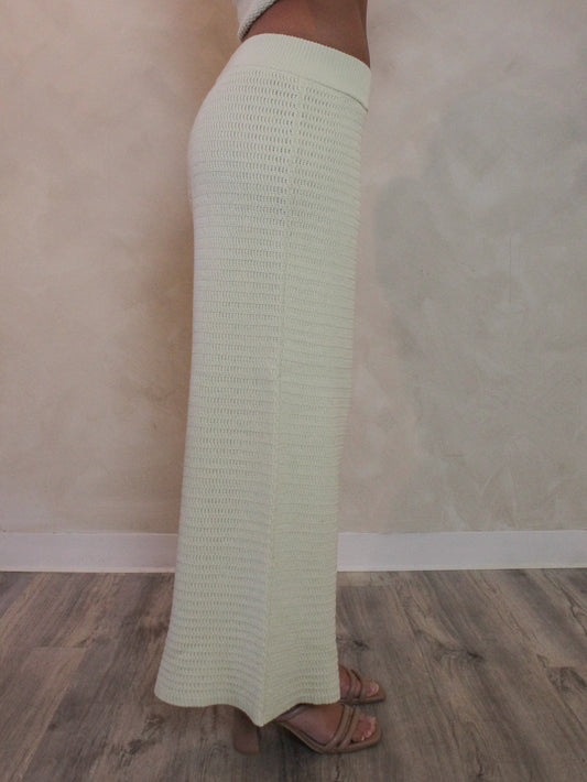 Woman wearing wide leg light green knit pants.