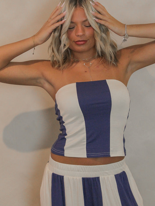 Woman wearing a blue and white striped tube top