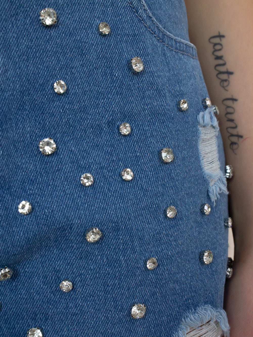 Detail shot of womens rhinestone, sparkle, denim shorts