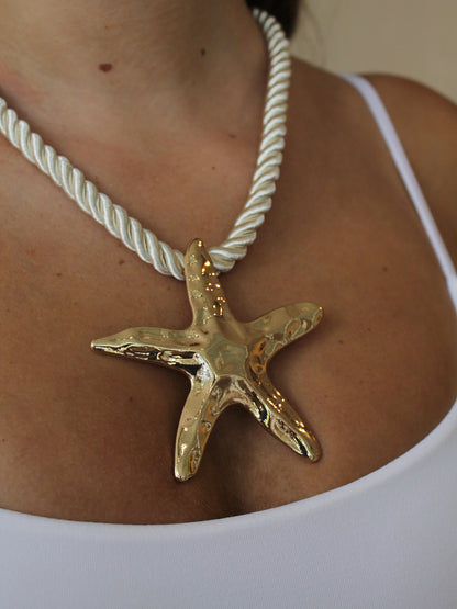 Gold starfish pendant on a white rope necklace