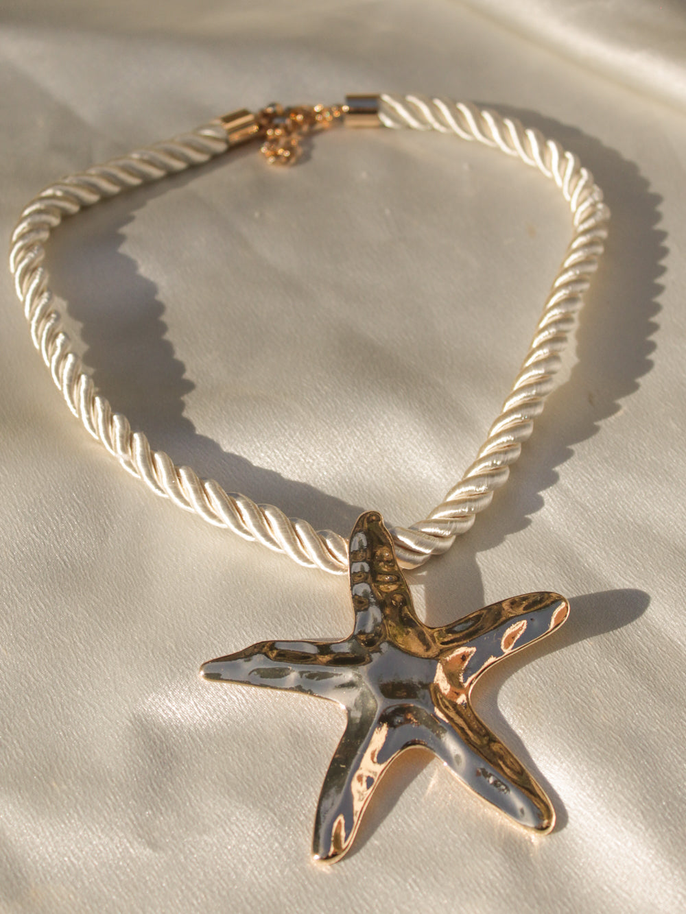 Gold starfish pendant on a gold rope necklace