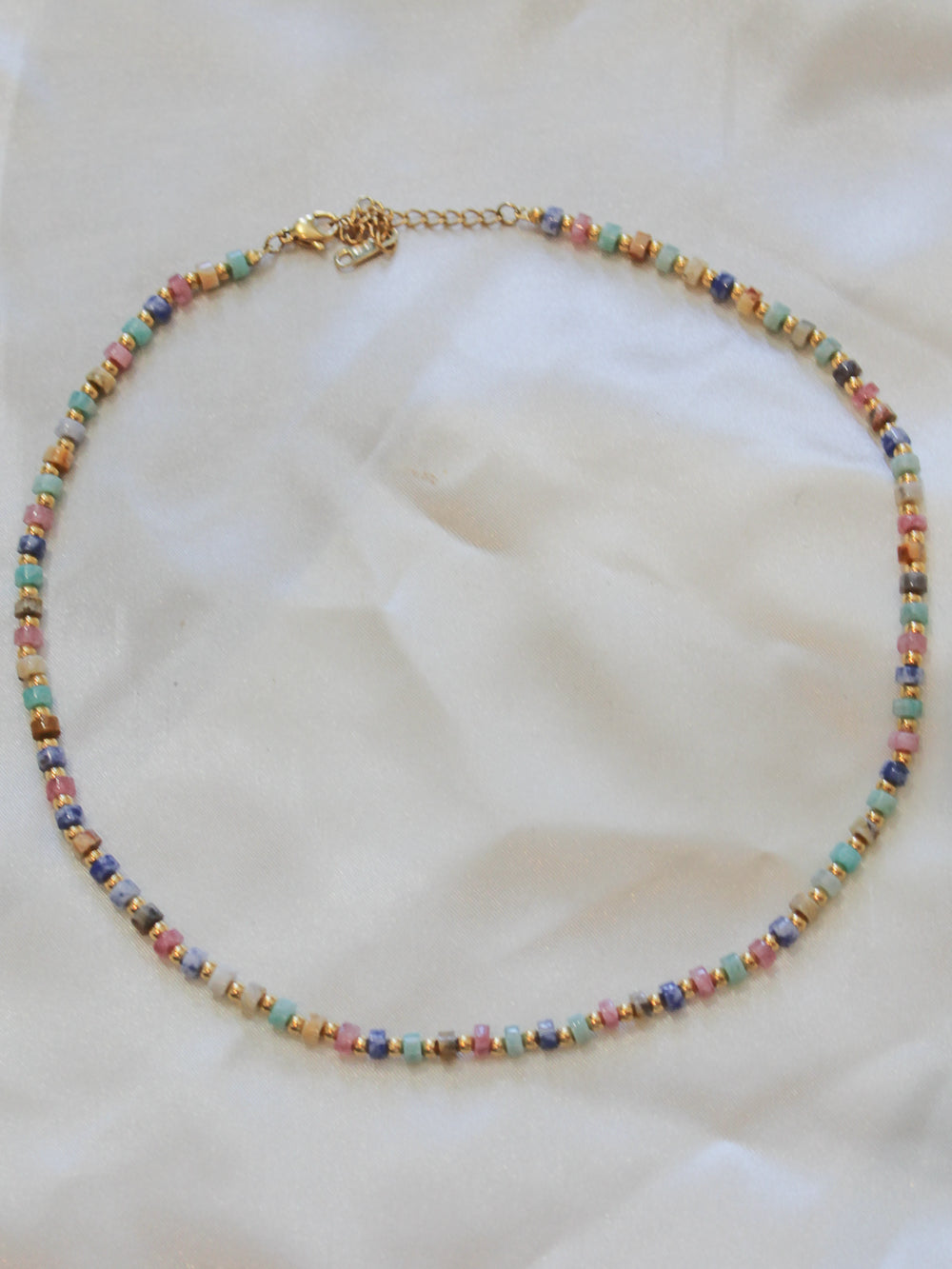 A delicate beaded necklace with small multicolored beads.