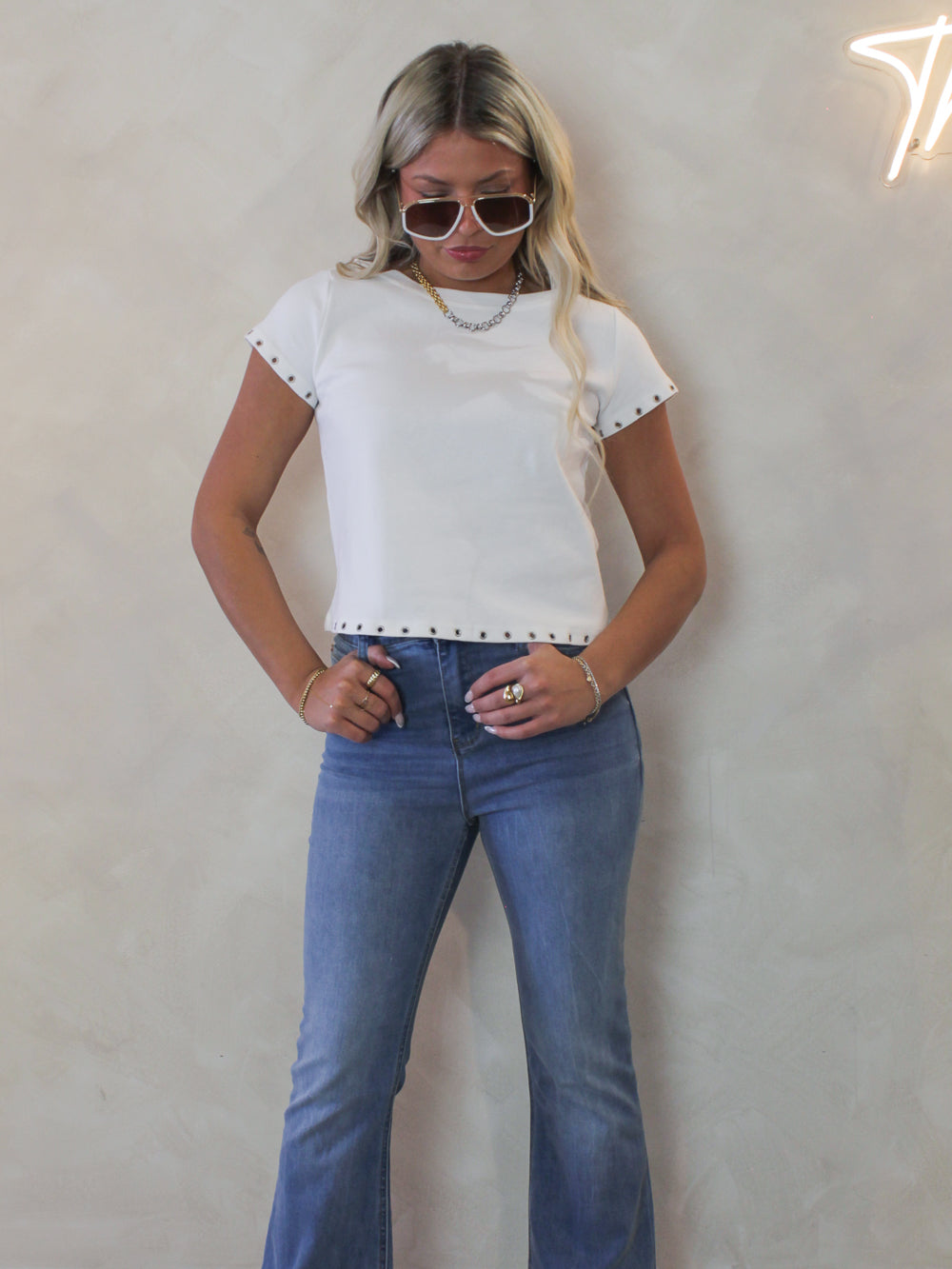 Model wearing a white tee and jean outfit 