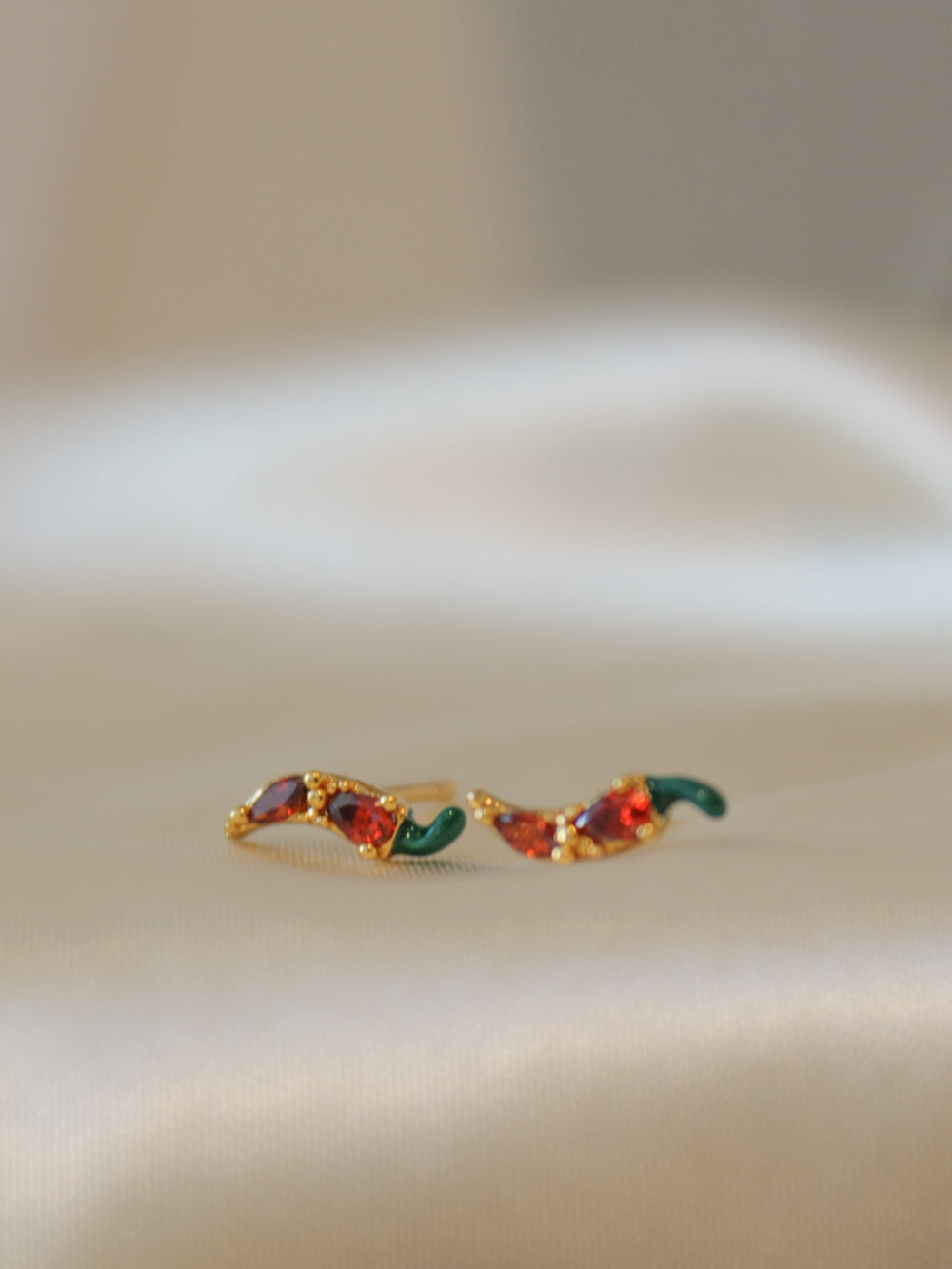 a pair of tiny chili pepper studs for women