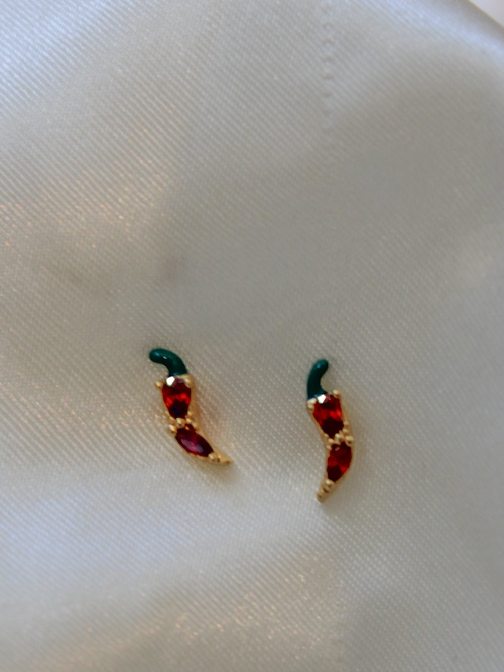 a pair of tiny chili pepper stud earrings for women