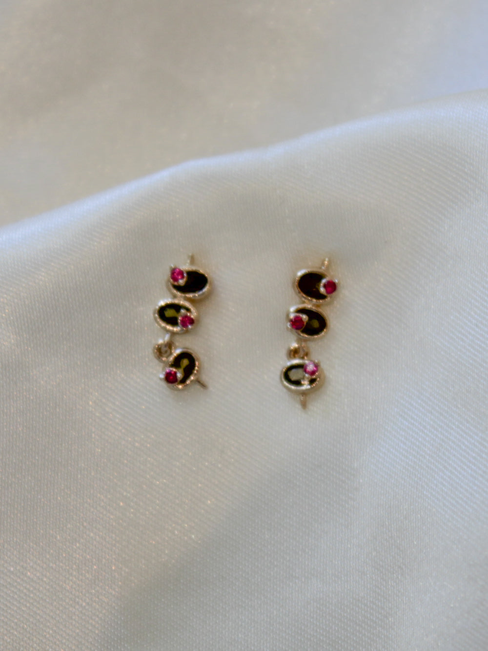 a pair of mini olive stud earrings