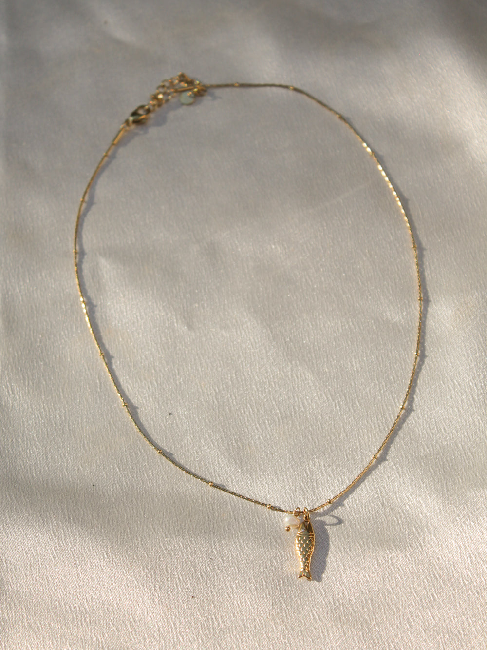 Gold necklace with a seahorse pendant 