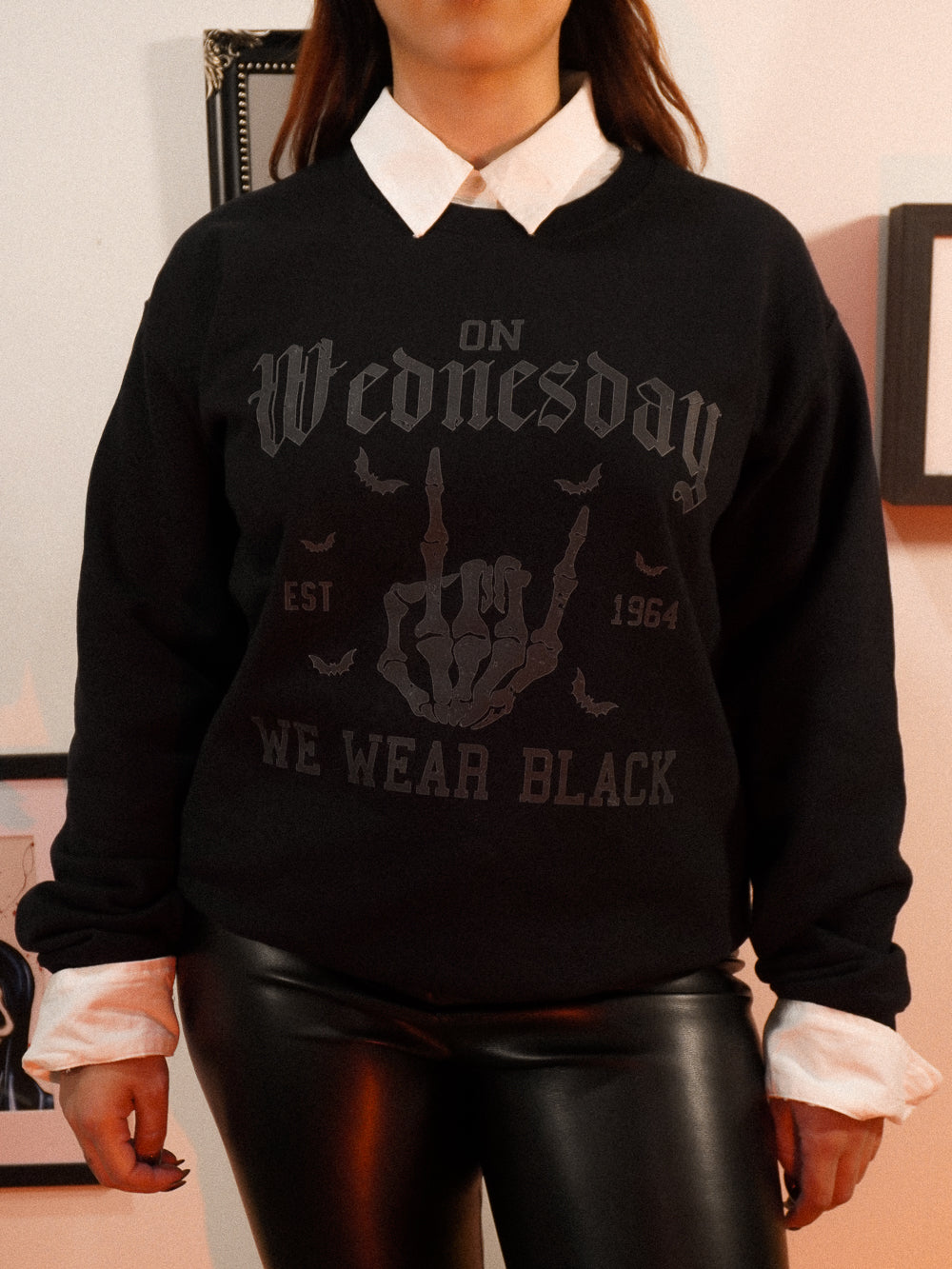 Black sweatshirt with 'On Wednesdays We Wear Black' text 