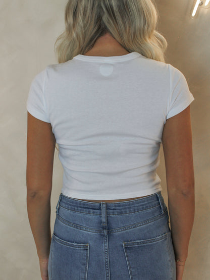 Back view of a woman wearing a white baby doll tee