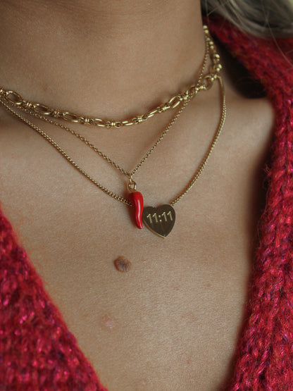 Gold necklace stack featuring a gold chain, italian pepper necklace and 11:11 charm necklace