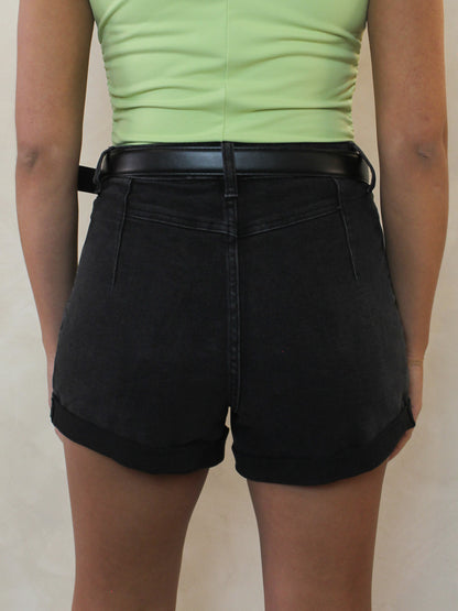 A pair of black denim shorts with cuffed hems from the back 