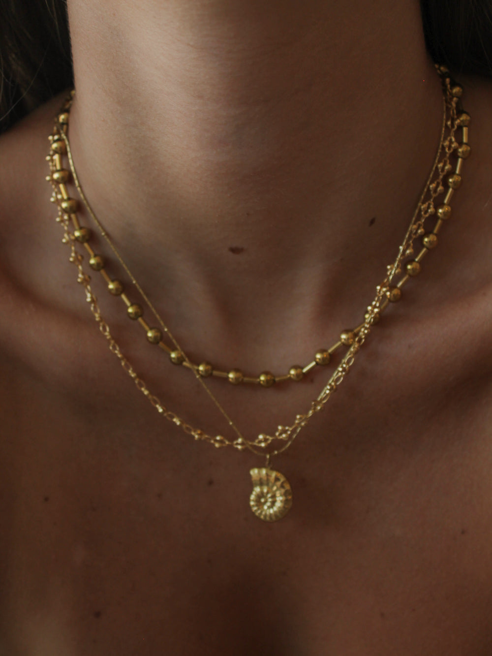 a girl wearing a gold summer stack