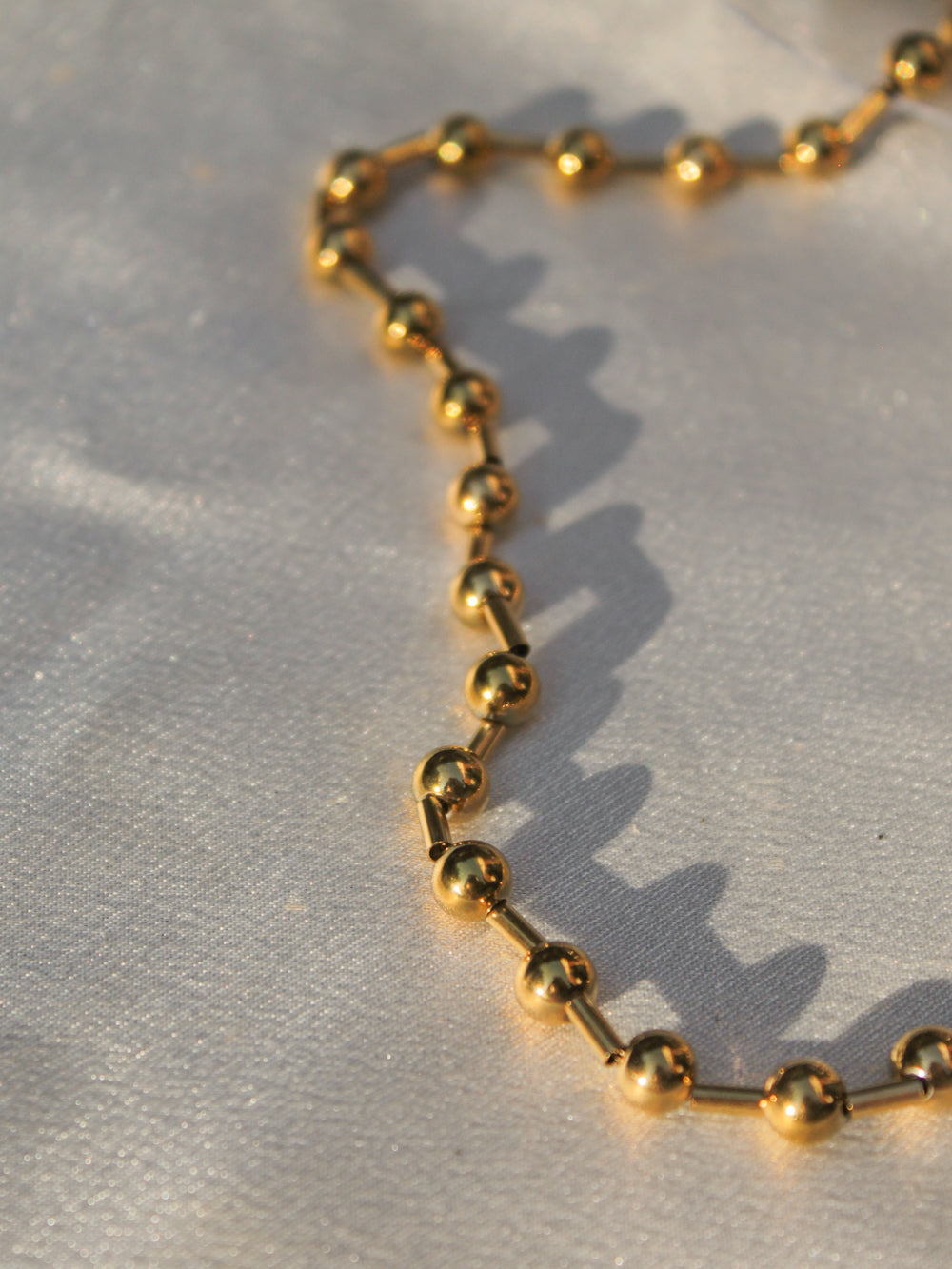 a gold ball chain detail
