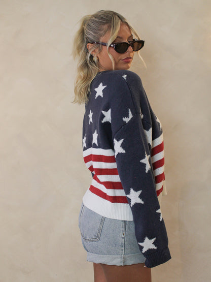 Side view of a woman wearing an american flag sweater