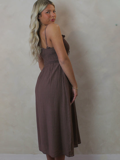 Model wearing a brown midi dress for spring 
