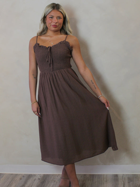 Model wearing a brown smoked midi dress for spring 