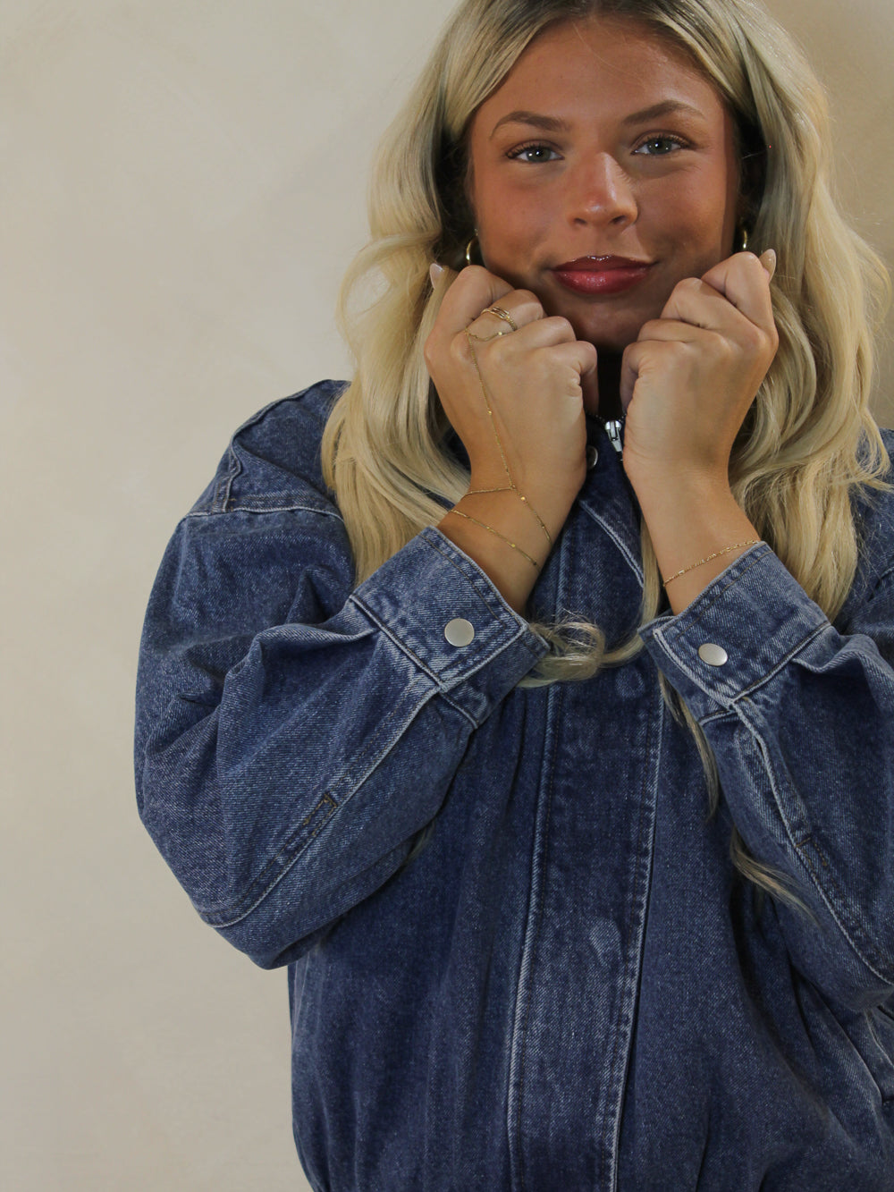 Detail shot of a model wearing a long sleeve denim jacket