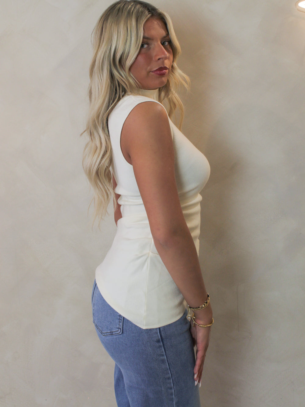 Model wearing an off white cap sleeve top 
