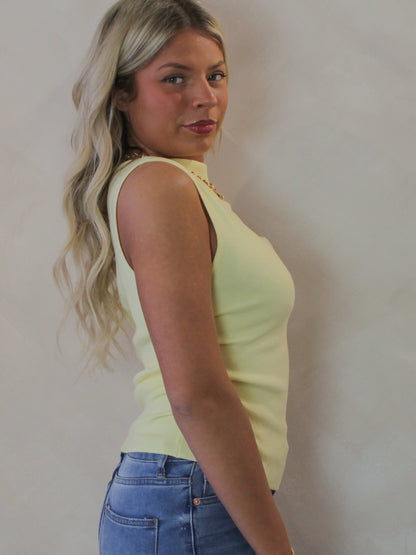 Model wearing a short sleeve, light yellow, ribbed top 