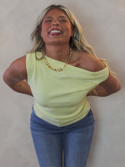 Model wearing a yellow, off the shoulder top 