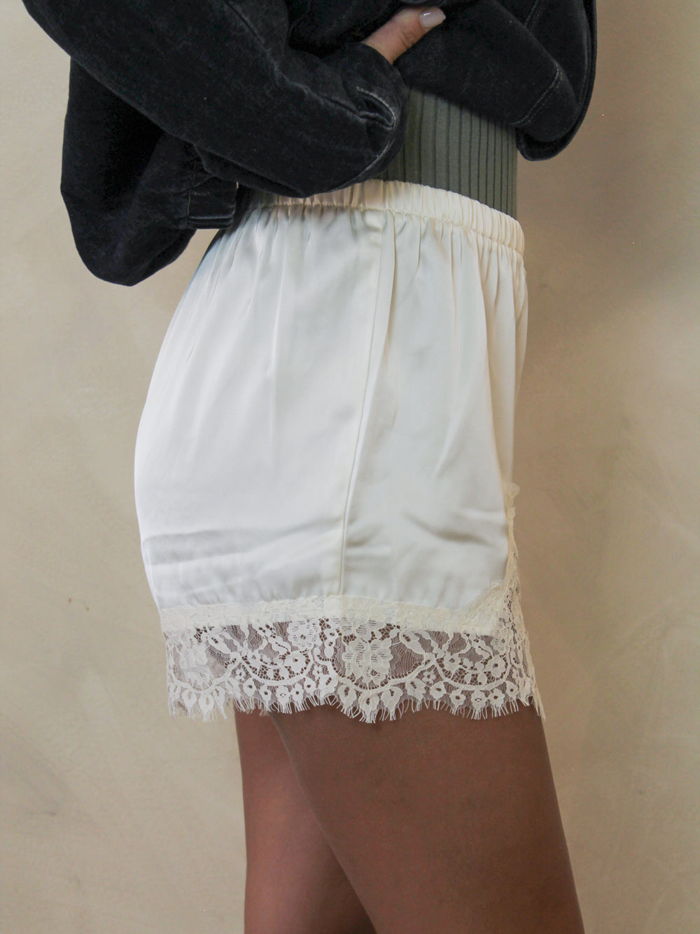 Cream shorts with a delicate lace hem.