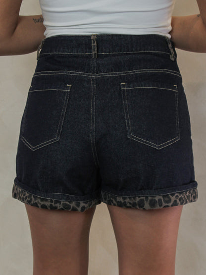 back view of  dark wash denim shorts for women with a leopard print cuffed hem