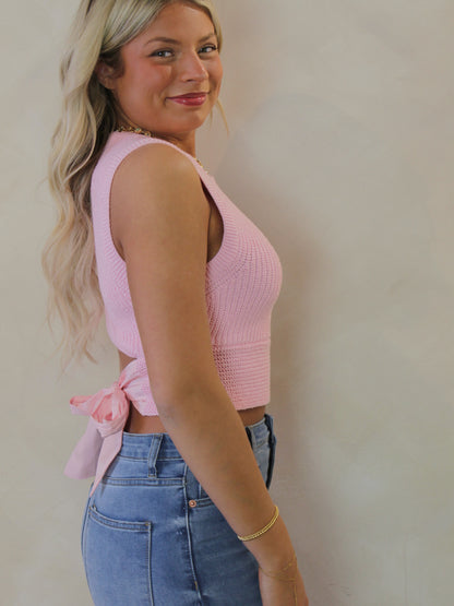 Side view of a light pink sweater top 