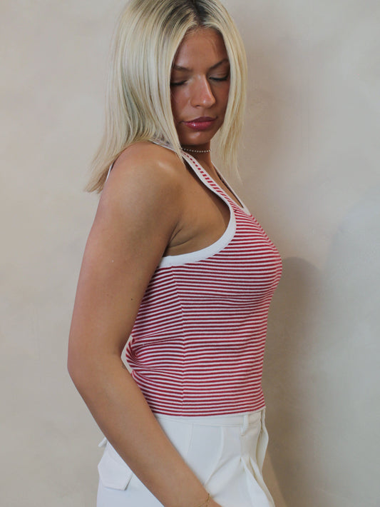 Woman wearing a red and white striped, ribbed tank top.