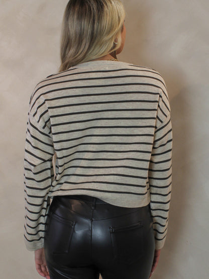 Woman wearing a grey stripe sweater 