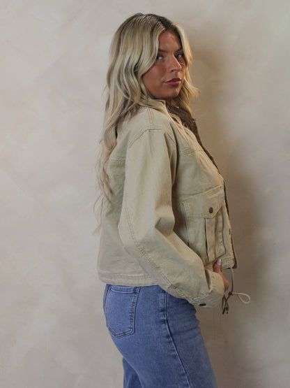 Woman wearing a tan denim jacket 