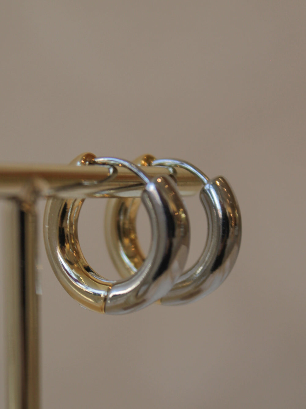 Close-up of a gold and silver hoop earring 