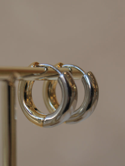 Close-up of a gold and silver hoop earring 