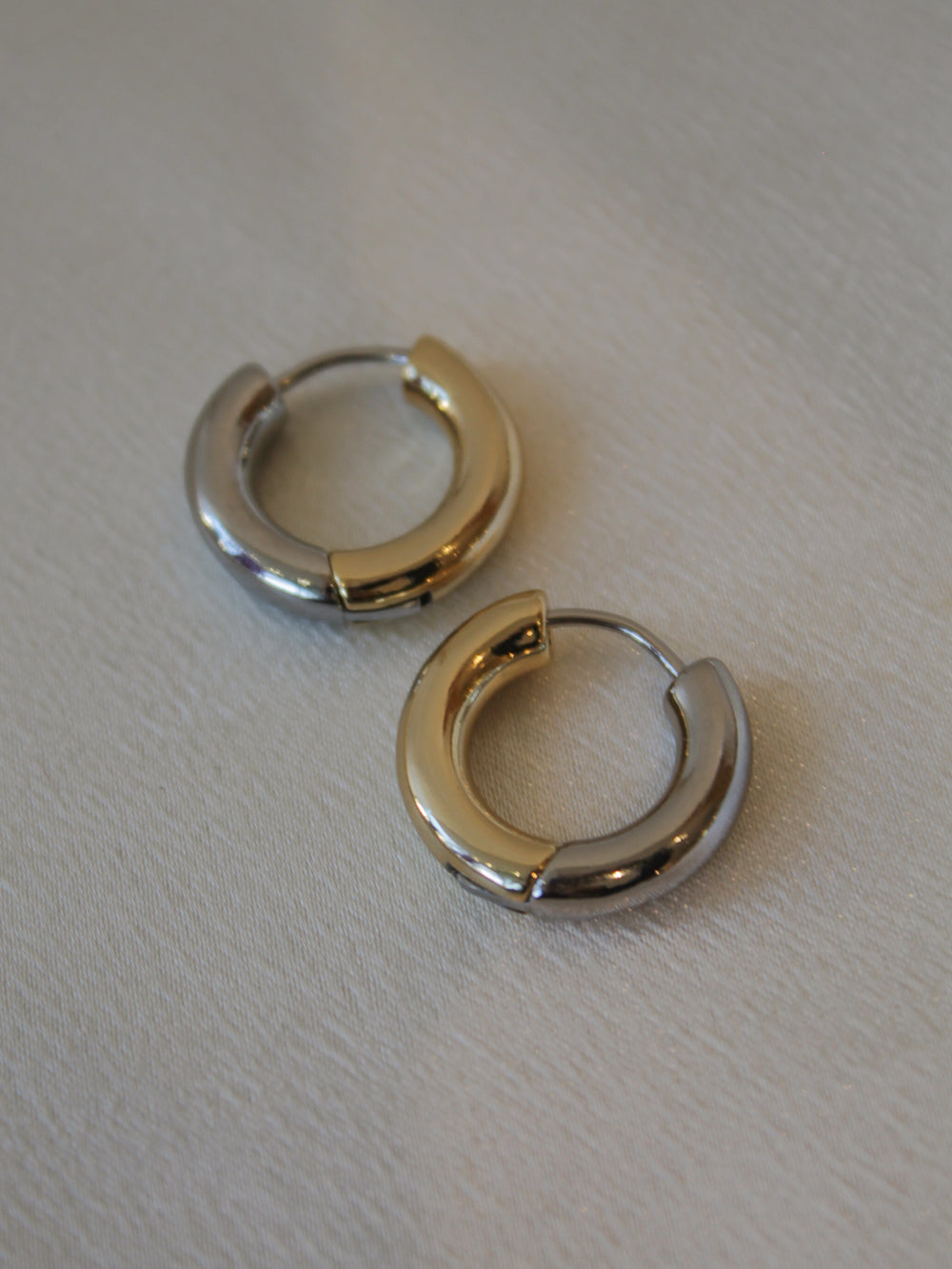 A pair of half gold half silver, mixed metal hoop