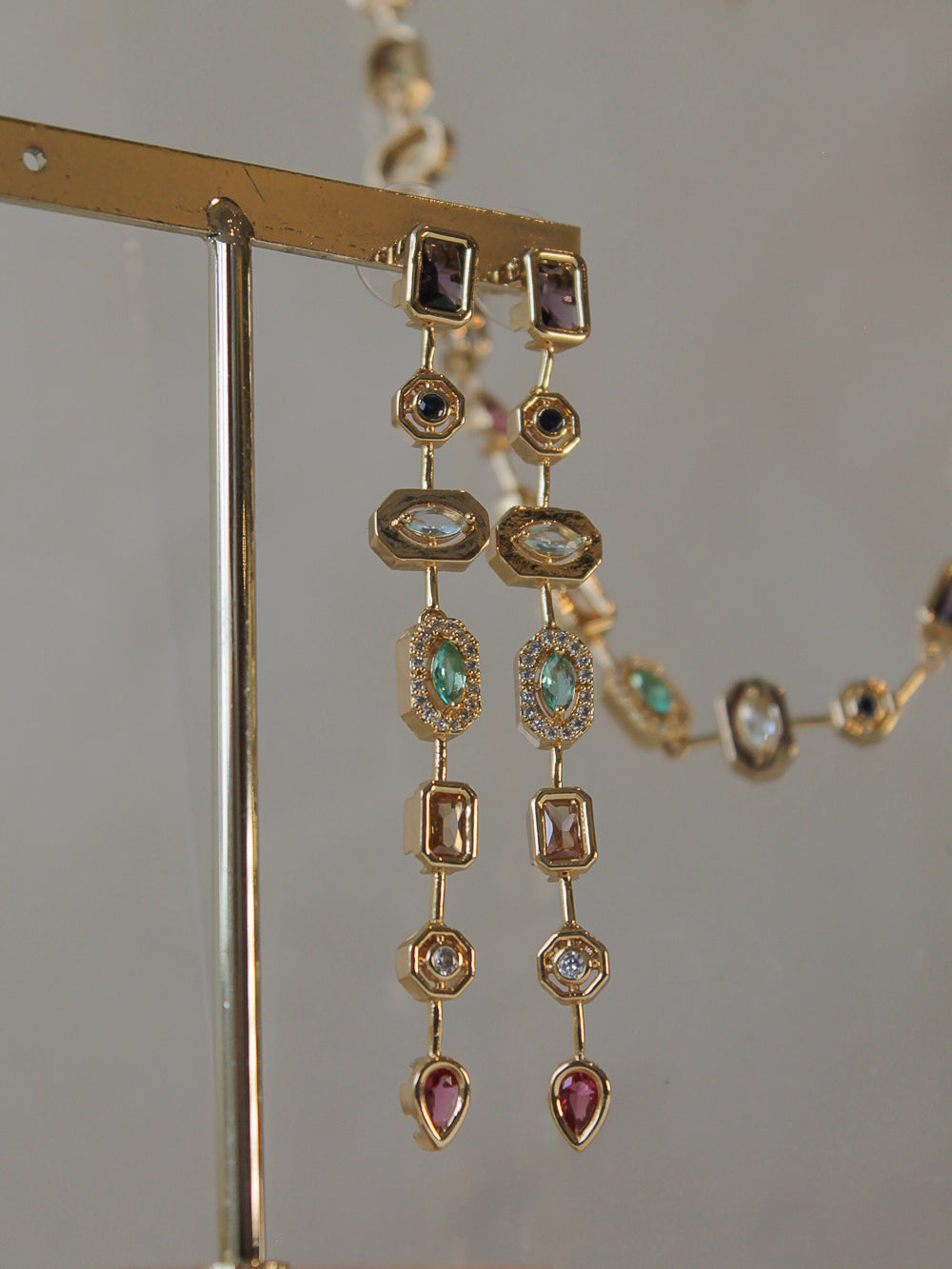 Gold dangle earrings with gemstones 