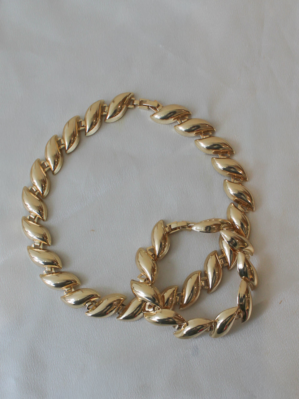 Matching gold statement necklace and bracelet with curved links 