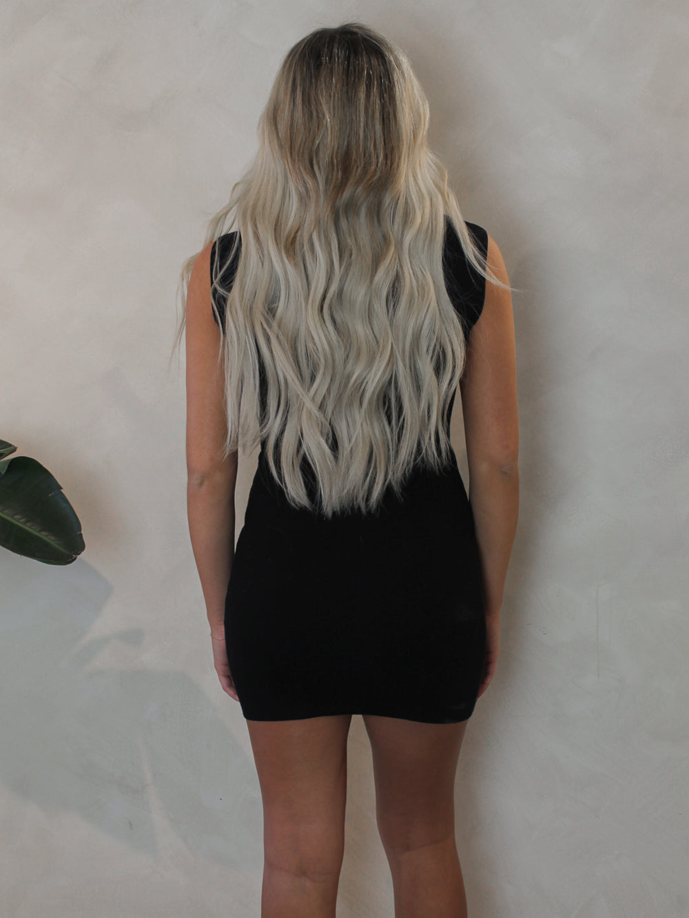 Woman wearing a short black mini dress  