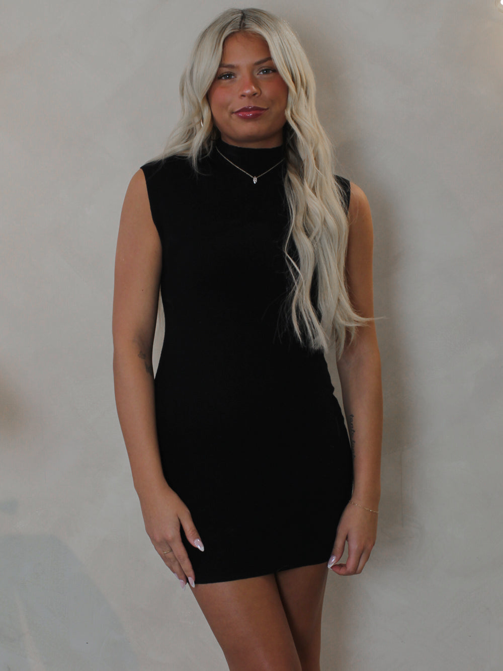 Woman wearing a short black mini dress  by Olivaceous