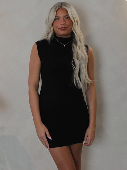 Woman wearing a short black mini dress  by Olivaceous