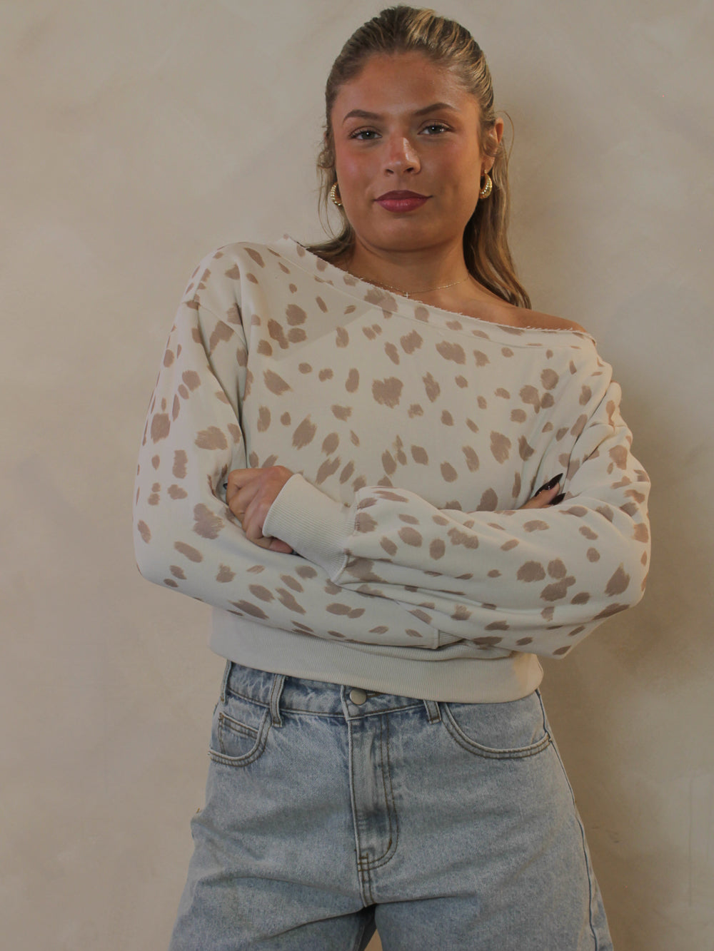 Cream off-the-shoulder fawn print sweatshirt.