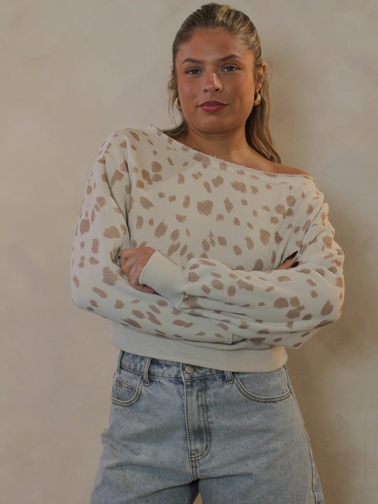 Cream off-the-shoulder fawn print sweatshirt.