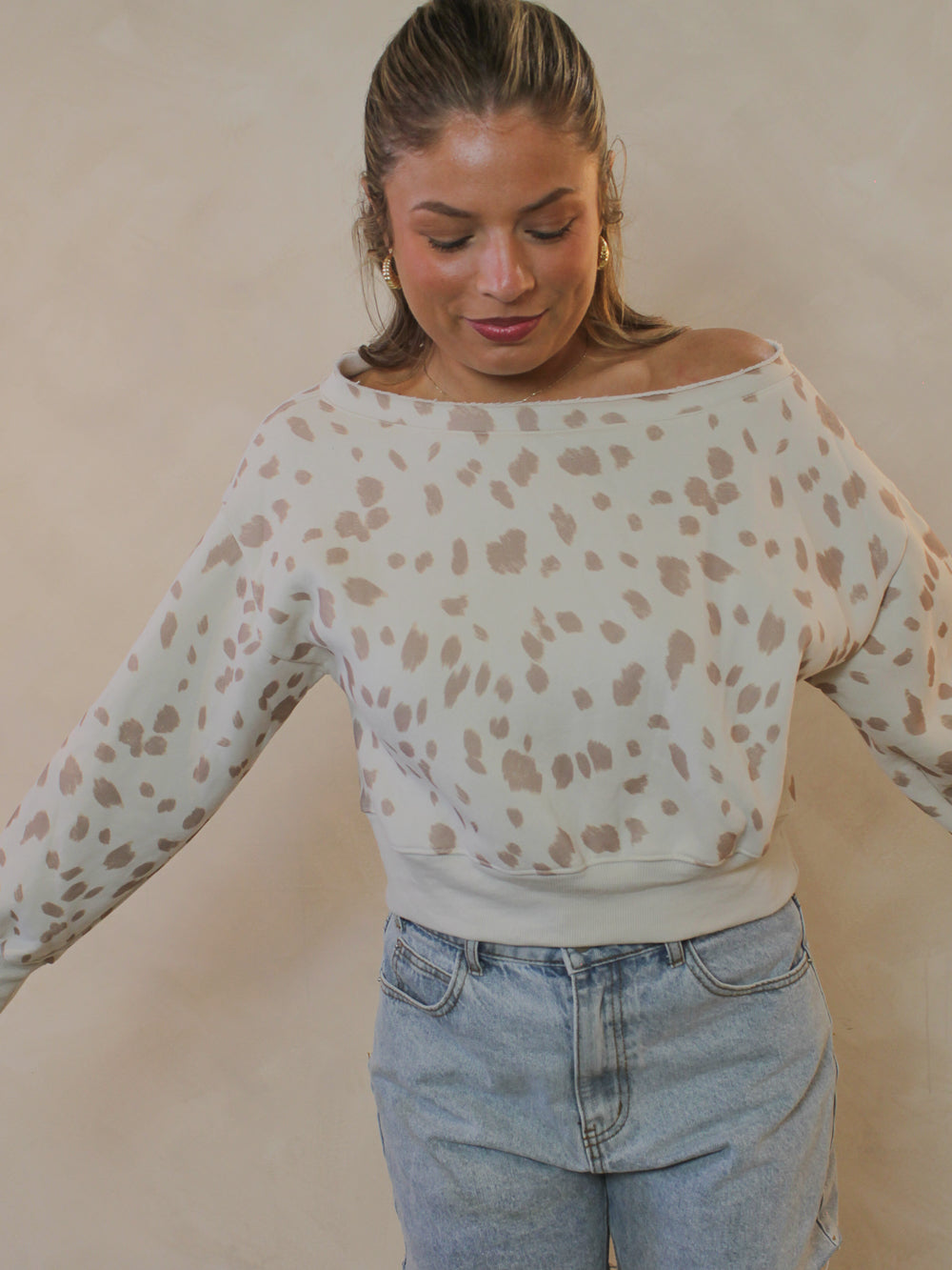 A bambi print off-the-shoulder cropped sweatshirt.