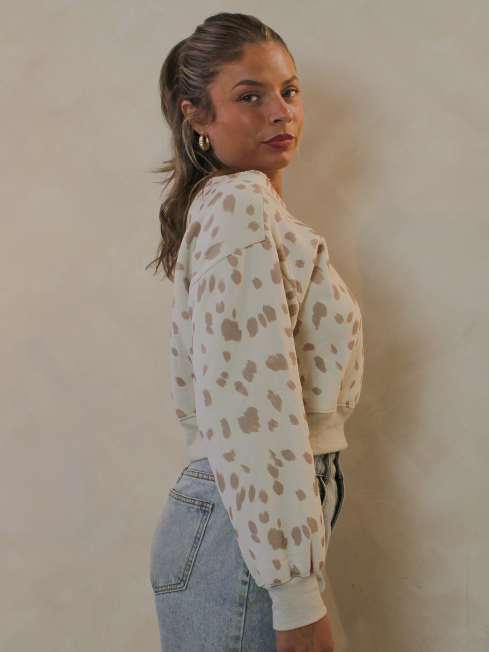 Side view of a Bambi print cropped sweatshirt.