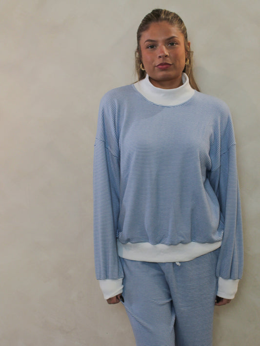 Blue and white, thin-stripe, mock neck lounge top styled with matching pants.