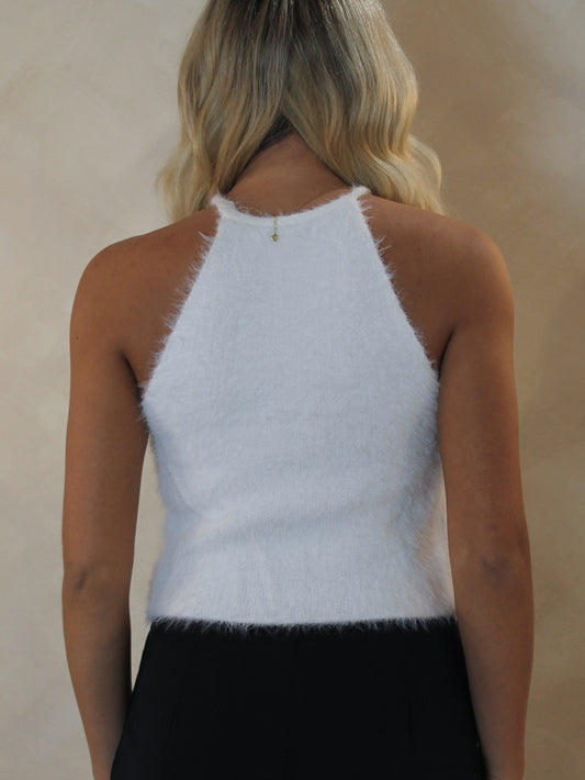 back view of a woman wearing a fuzzy knit tank top for the holidays