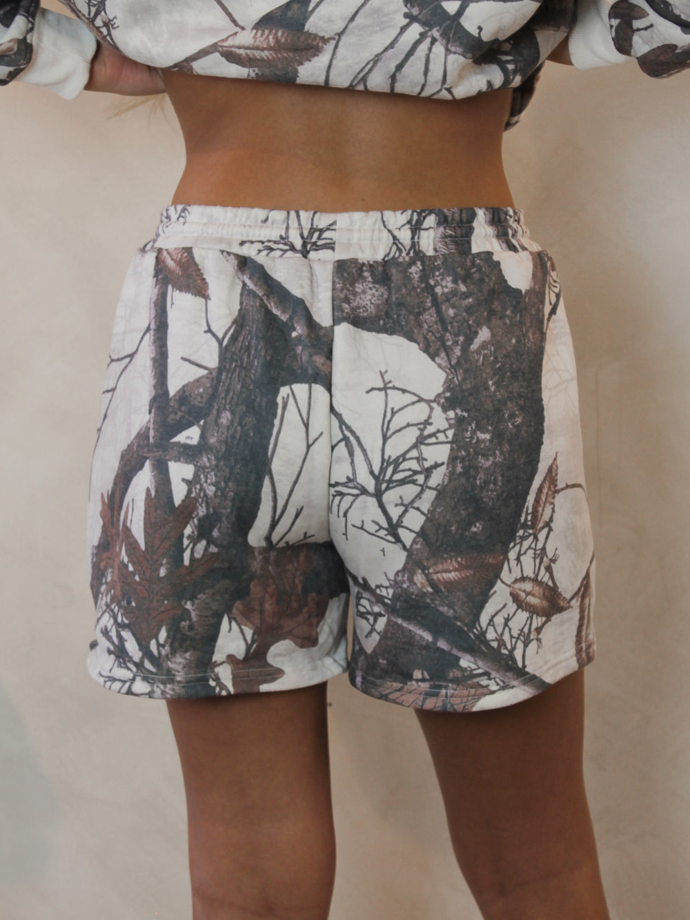 Model wearing camo sweats shorts for women 