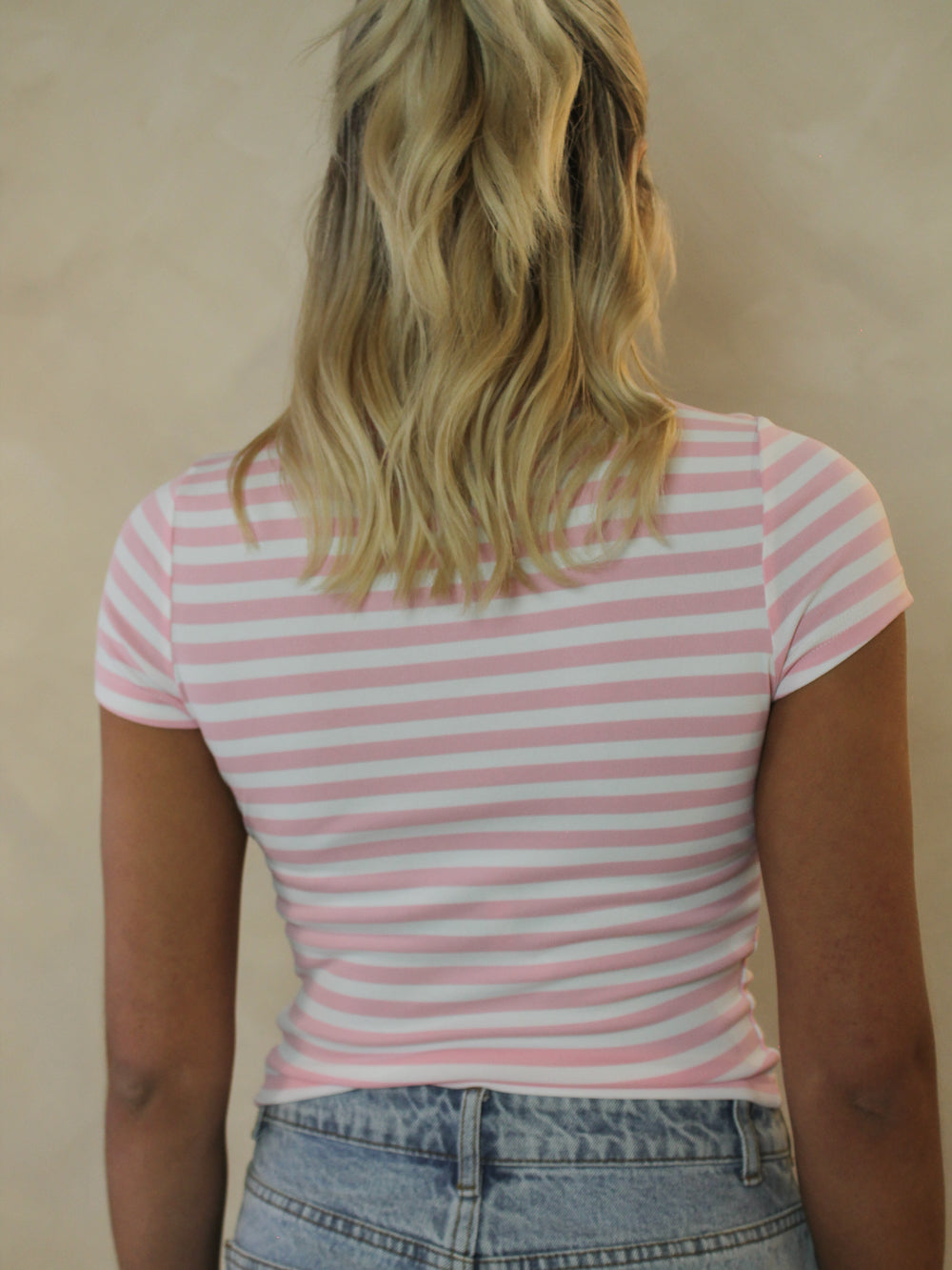 Back view of a pink and white striped top