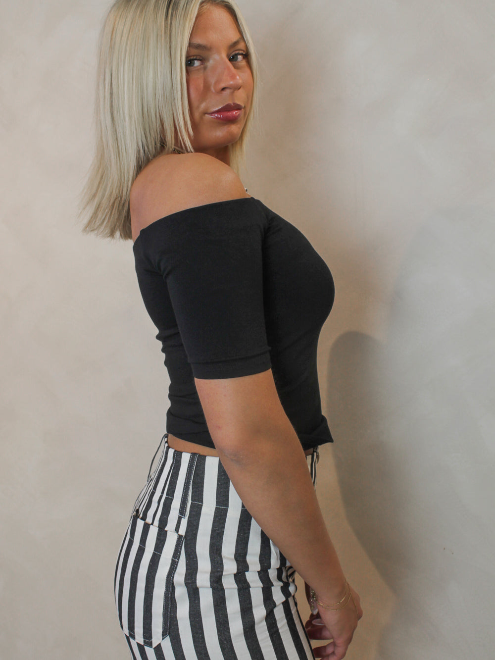 side view of a black off the shoulder top