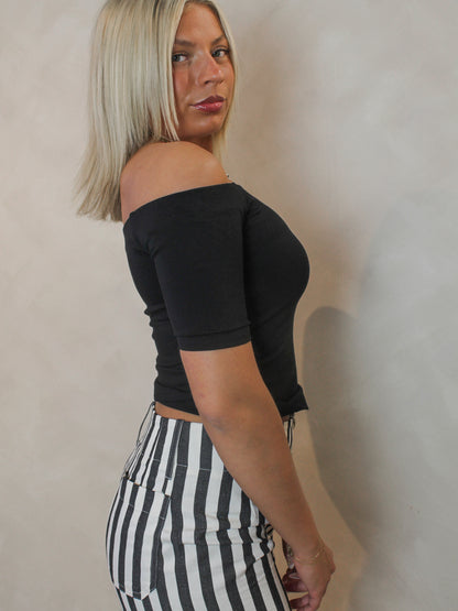 side view of a black off the shoulder top