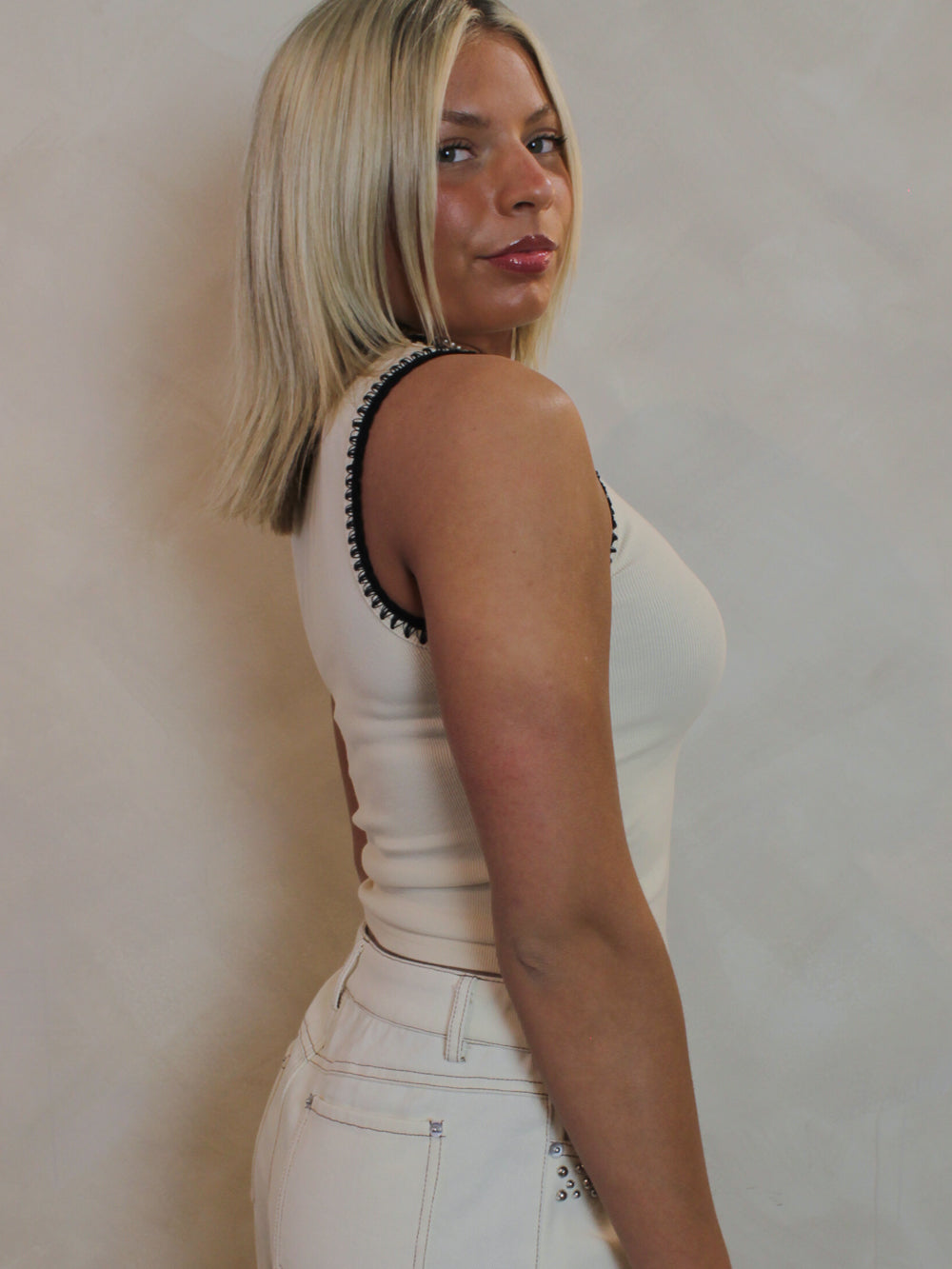 Cream tank top with black stitching 