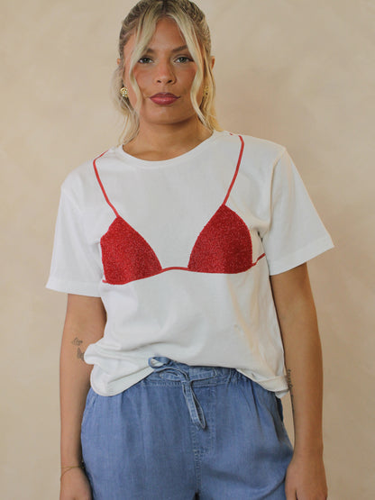 Woman wearing a white tee with a red bikini graphic and styled with tencel denim shorts